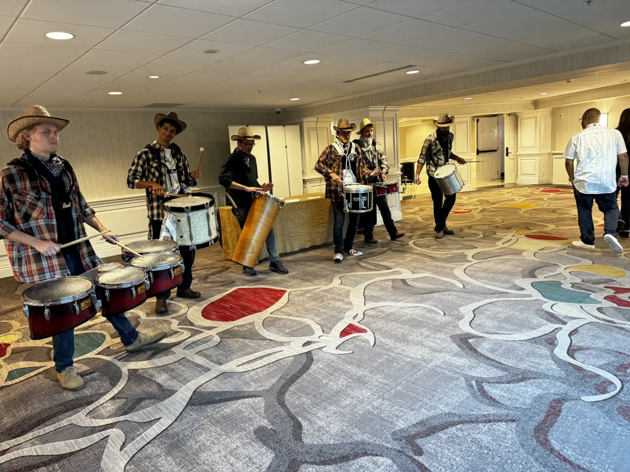 Six Nashville drumline performers moving through a corporate event venue